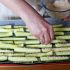 Die Zucchini-Parmesan-Mischung über die Fritten streuen