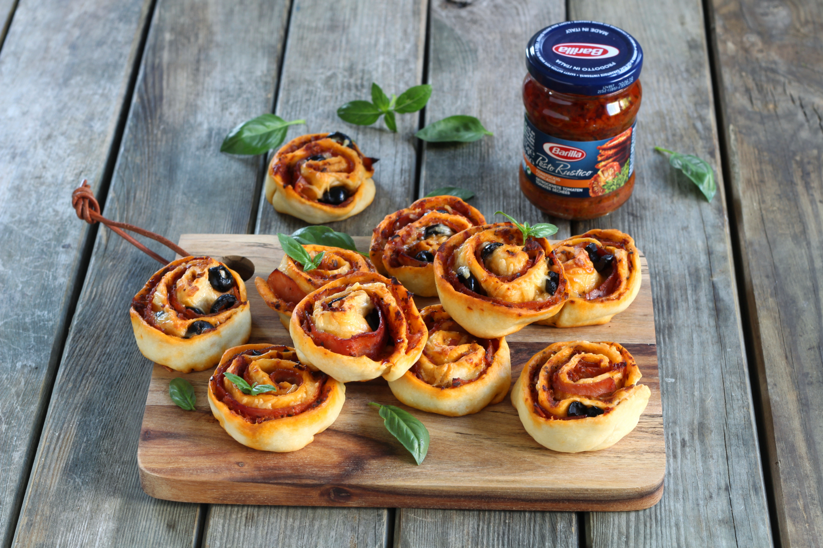 Rustikale Pizzaschnecken mit rotem Pesto, Schinken und schwarzen Oliven